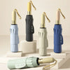 A collection of automatic folding umbrellas in various colors, including light blue, beige, and dark blue.