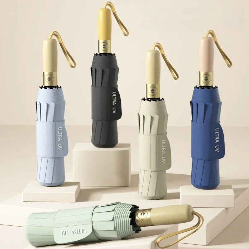 A collection of automatic folding umbrellas in various colors, including light blue, beige, and dark blue.