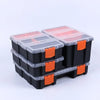A stack of black and clear plastic tool box organizers with orange accents.