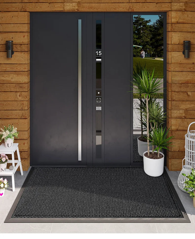 A dark gray modern door with vertical glass panels and a black non-slip doormat in front of it.