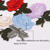 A collection of colorful rose and butterfly embroidered iron-on patches in various shades of pink, blue, and purple on a whit