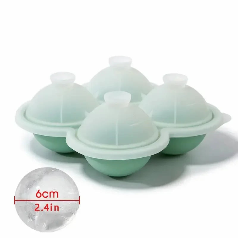 A set of light green silicone ice cube trays with removable molds and a measurement guide showing 6cm or 2.4in.