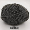 A ball of dark gray 4-ply milk cotton yarn for knitting and crochet.