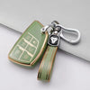A light green TPU car key fob cover attached to a silver keychain with a black emblem.