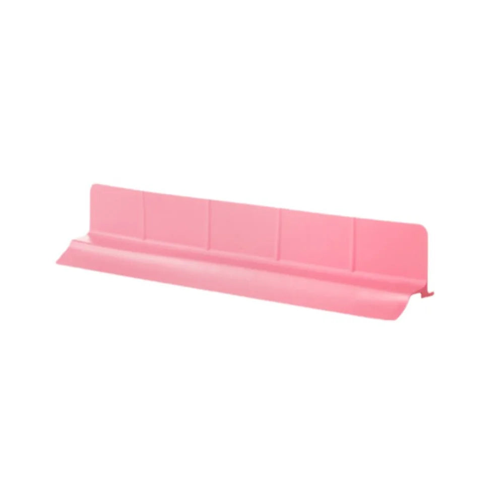 A pink flexible silicone sink splash guard with suction cups.