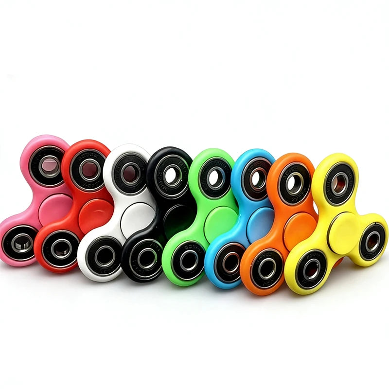 A collection of colorful smooth-spin fidget spinners in various colors like pink, red, black, white, green, blue, and orange.
