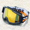 A pair of black and orange retro motorcycle sunglasses with yellow lenses resting on a light surface.