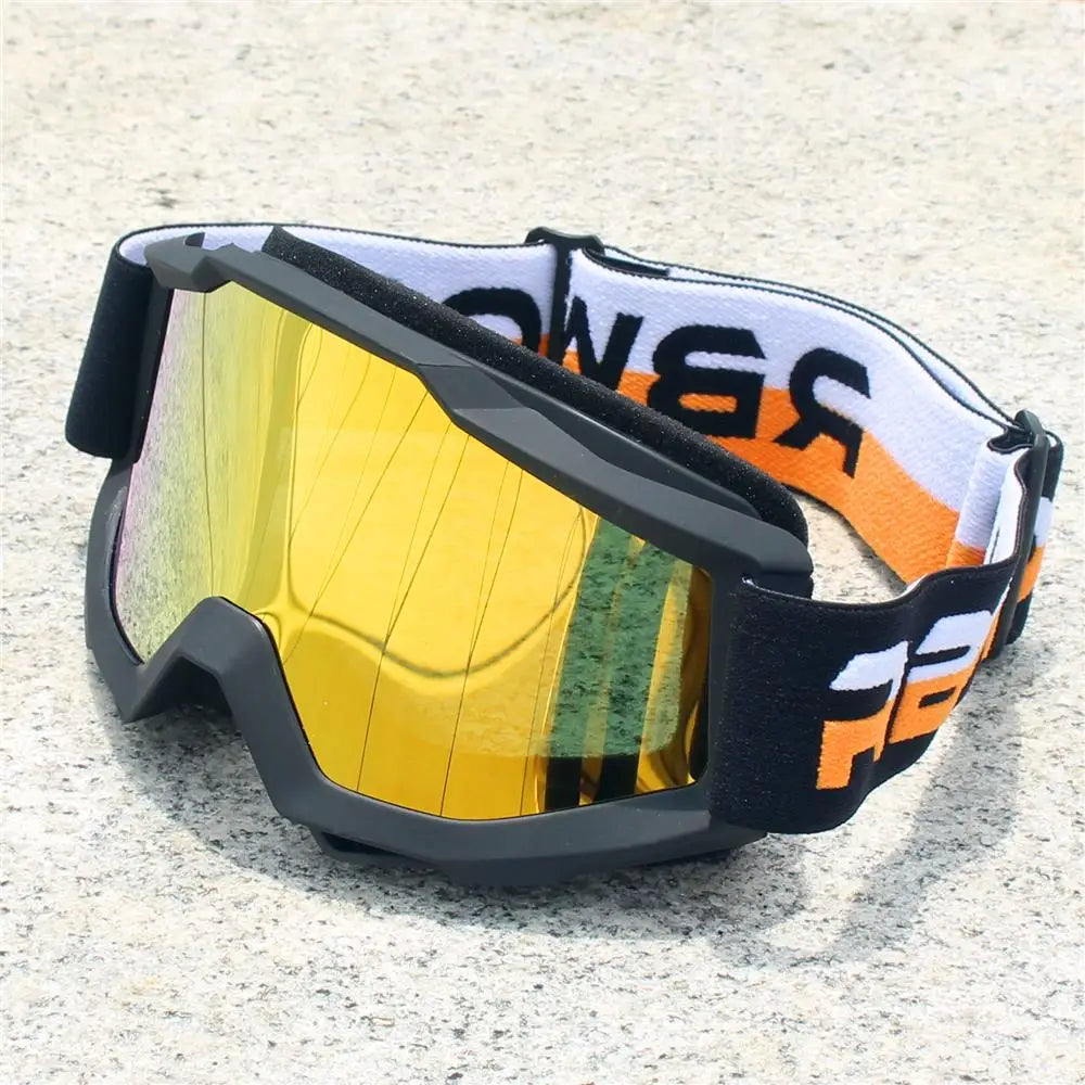 A pair of black and orange retro motorcycle sunglasses with yellow lenses resting on a light surface.