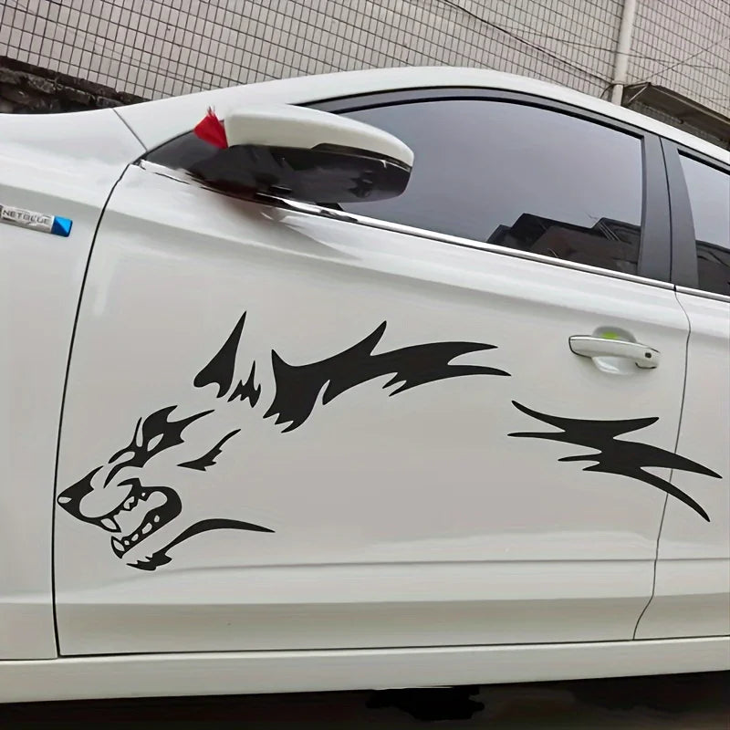 A white car door features black vinyl decals shaped like a wolf head and lightning bolts.