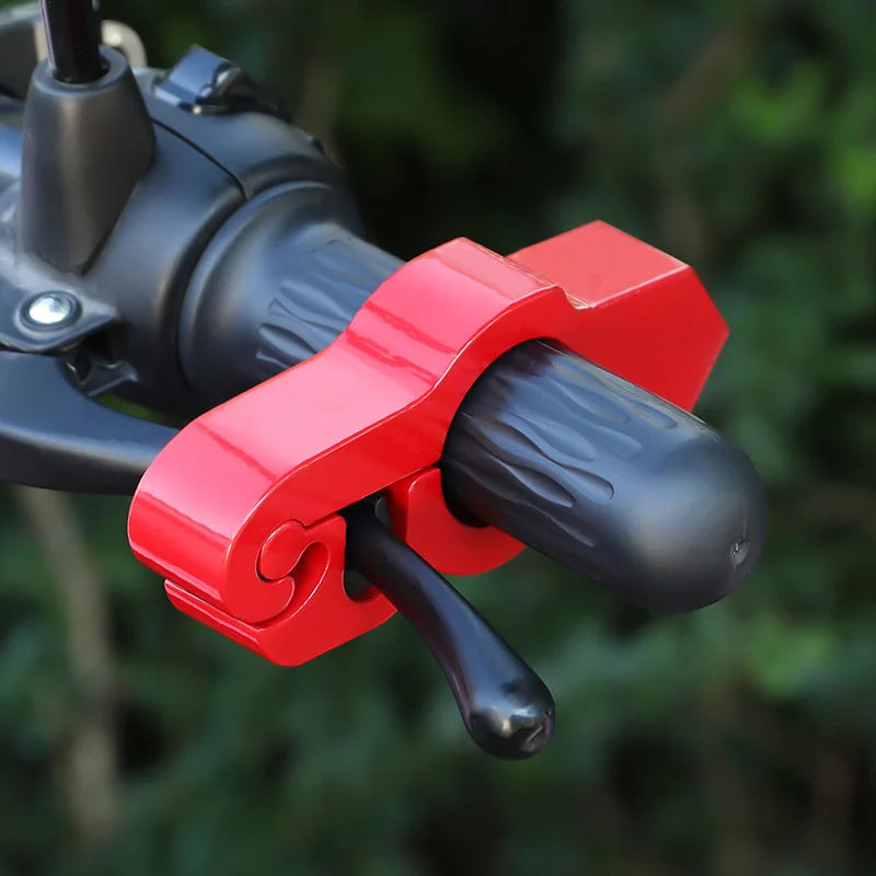 A close-up of a red motorcycle handlebar brake lock security device attached to the handlebars.