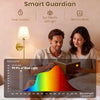 A man and a woman are using a Smart Guardian light lamp in a bedroom setting.