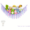 Bohemian handwoven corner toy storage net with colorful plush toys and tassels