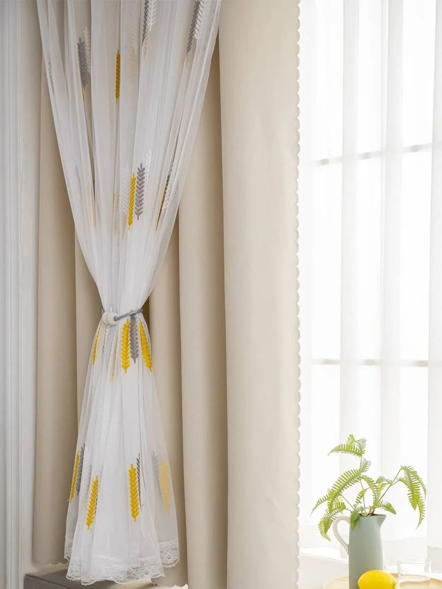 Elegant white and yellow wheat field embroidered curtain with lace trim hanging beside a window.