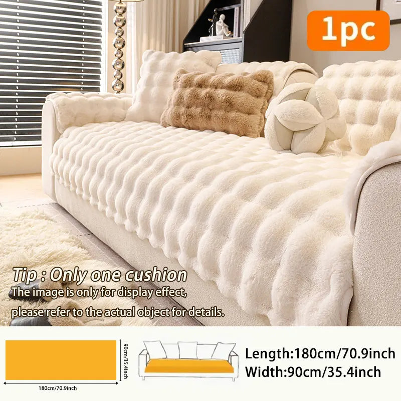 A beige plush sofa cushion cover displayed on a sofa with decorative pillows.