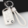 A white TPU car key fob cover for VW, Skoda, Seat & Audi with a metal keyring attached.