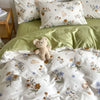 A light green floral bedding set featuring a duvet cover and pillows with white and soft yellow accents.