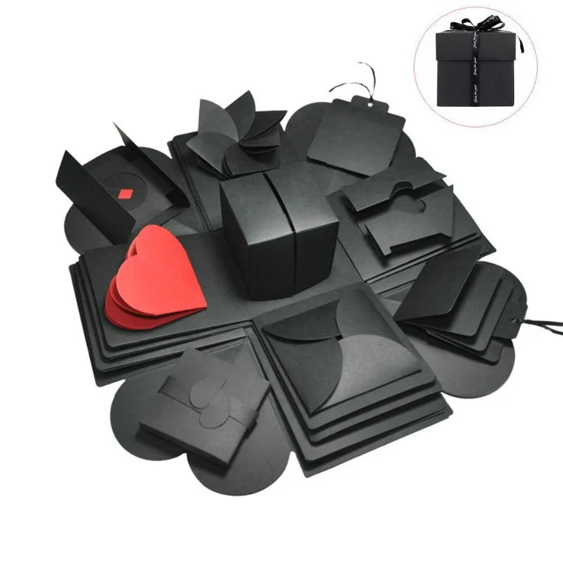 A black DIY explosion photo gift box with various layered and folded paper shapes, including a red heart.