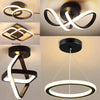 A modern black LED ceiling light fixture with a white, stylized clover design shown from multiple angles.