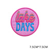Pink embroidered patch with the text LAKE DAYS in colorful script