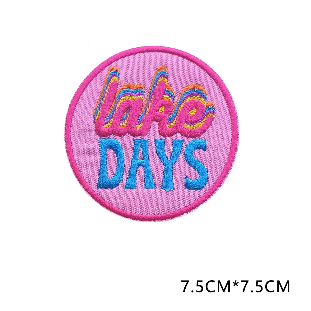 Pink embroidered patch with the text LAKE DAYS in colorful script