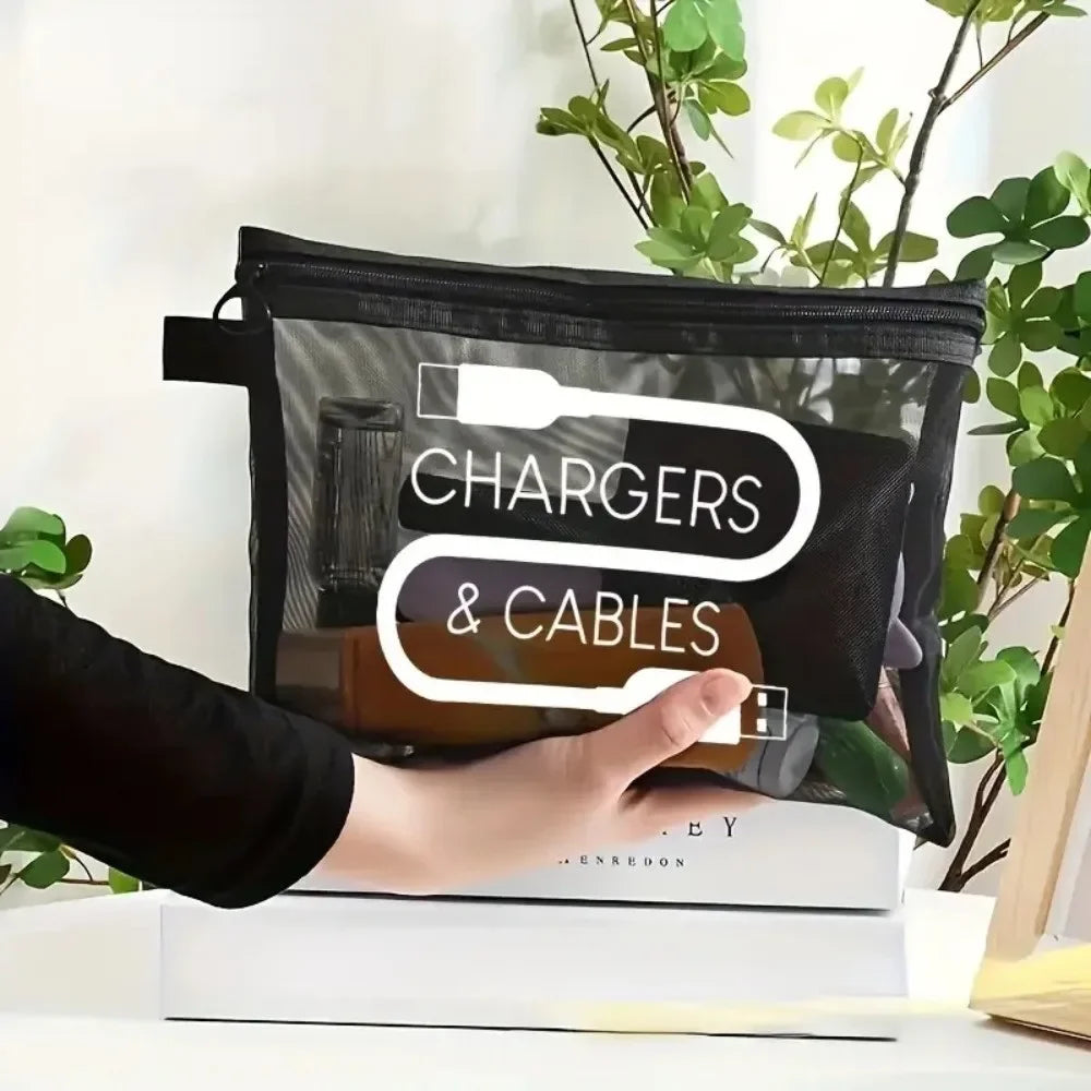 A hand holds a black canvas charger and cables storage pouch with white text on a white surface.