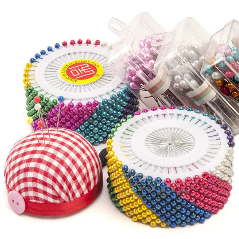 Colorful round pearl straight pins for sewing and crafts in various colors like pink, green, yellow, and silver.