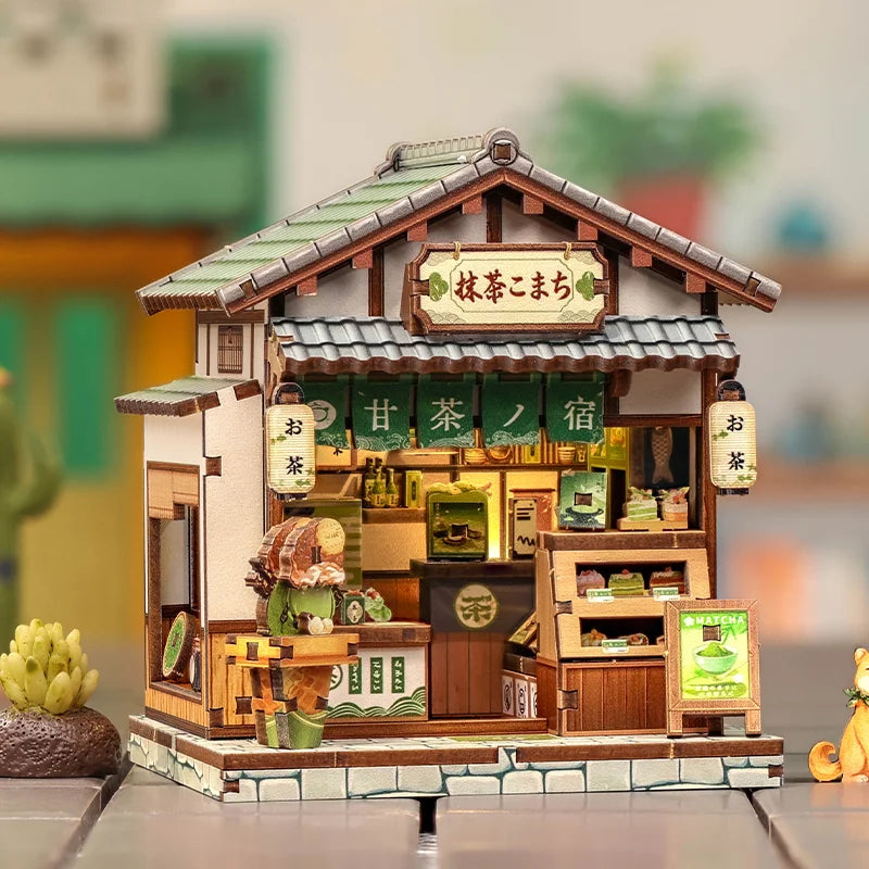 A detailed miniature Japanese book nook kit featuring a traditional wooden house with lighting and decorative elements.