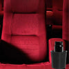 A close-up of a red upholstered chair with a black cup holder attached to the armrest.