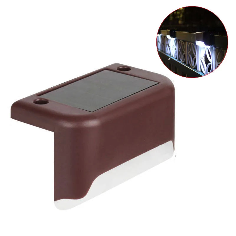 A brown solar deck light with a glass panel and an inset showing its illuminated LED step lights.