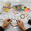Hands are assembling jewelry from various colored elastic cords and beads for DIY projects.