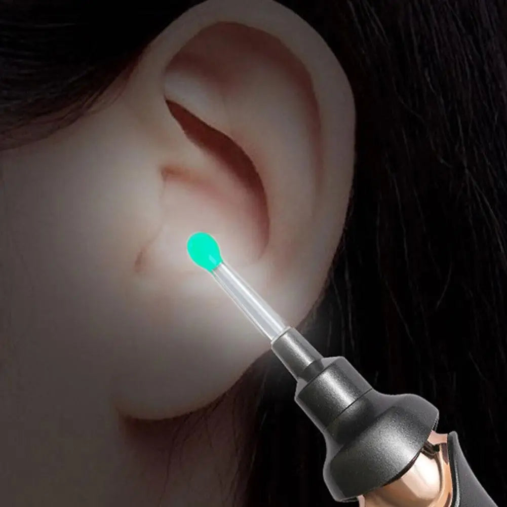 A close-up of a replacement ear spoon tip, bright green and clear, being inserted into an ear.