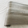 Roll of wood grain peel and stick wall decals in a gray tone