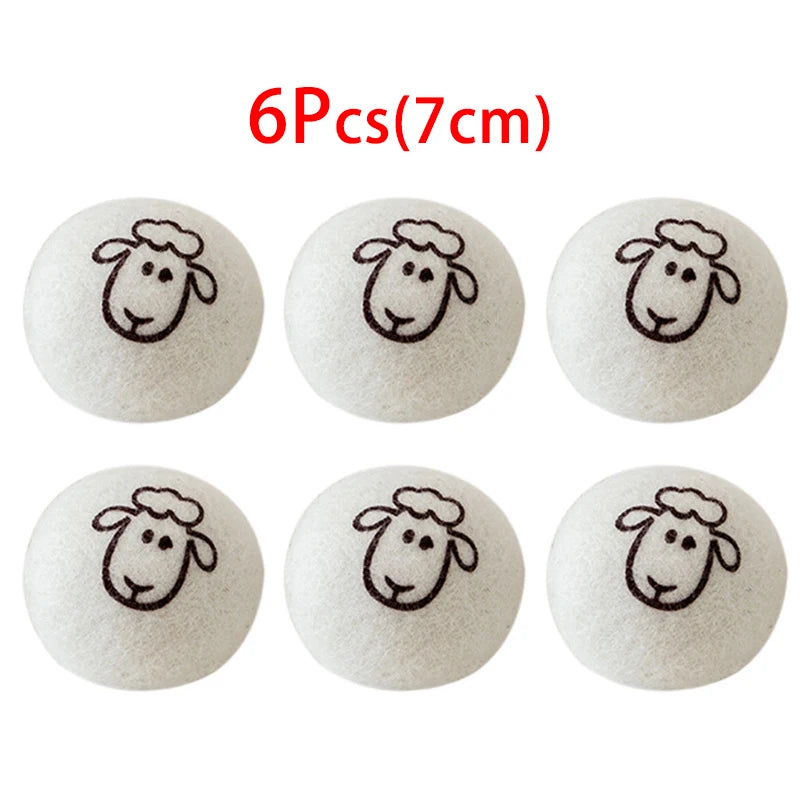 Six white wool dryer balls, approximately 7cm in diameter, shaped like sheep heads.