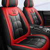 A pair of black and red leather car seat covers shown in a vehicle interior.