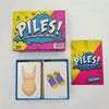 A box and deck of piles poker cards for a family game night featuring colorful illustrations.
