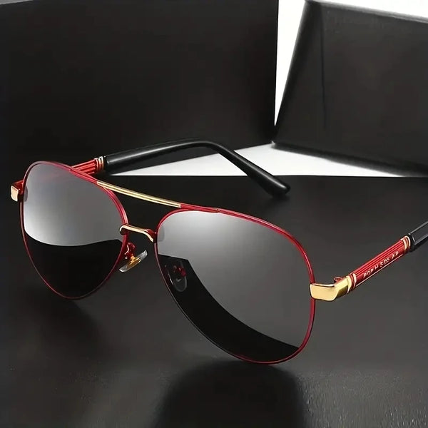 A pair of red-framed polarized sunglasses resting on a black surface.