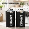 Two black laundry hampers with white text Laundry placed on a kitchen counter.