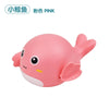 A pink cartoon whale bath toy featuring a cute face and fins.