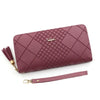 A mauve quilted PU leather wristlet clutch wallet with a gold chain and a matching strap.