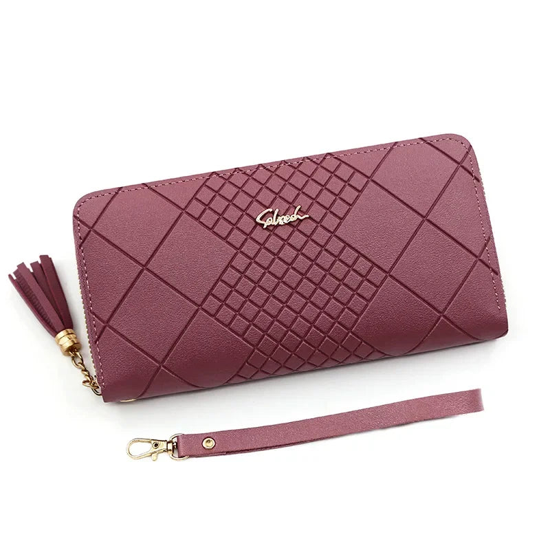 A mauve quilted PU leather wristlet clutch wallet with a gold chain and a matching strap.