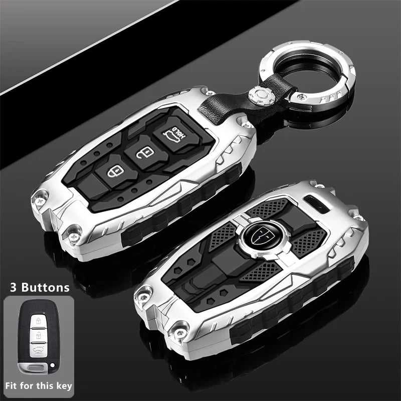 Silver protective key fob cover with a keyring and three buttons shown against a dark background.