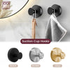Three suction cup towel hooks in black, silvery, and gold finishes shown against a white wall.