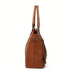 A brown PU leather tote bag with a detachable strap shown from the side.