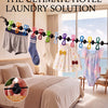 A portable travel clothesline featuring 12 colorful clothespins used for laundry on a bed.