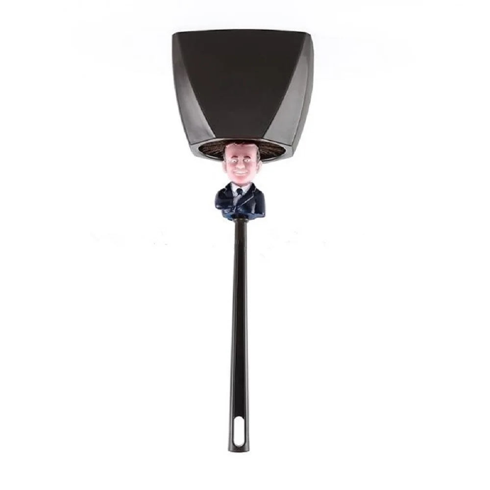 A black novelty toilet brush with a figure on the handle and a stand.