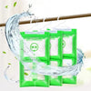 Green hanging bags of moisture absorbers being used to absorb water on a wooden rod.