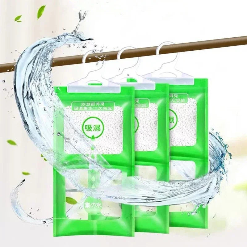 Green hanging bags of moisture absorbers being used to absorb water on a wooden rod.
