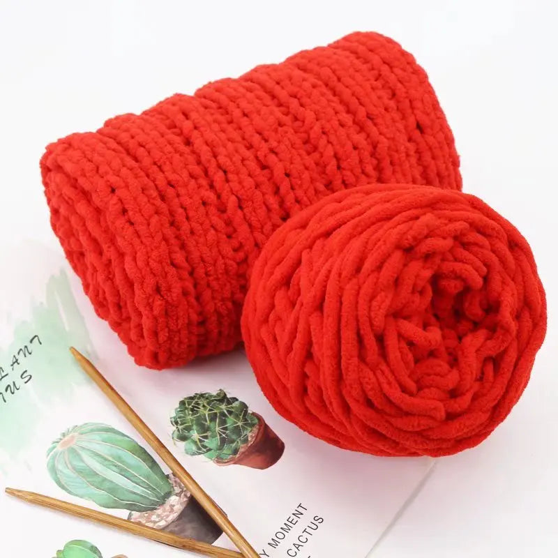 A ball of bright red chunky chenille yarn used for knitting or crocheting projects.
