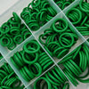A variety of green automotive air conditioning O-ring gaskets are arranged in a clear plastic tray.
