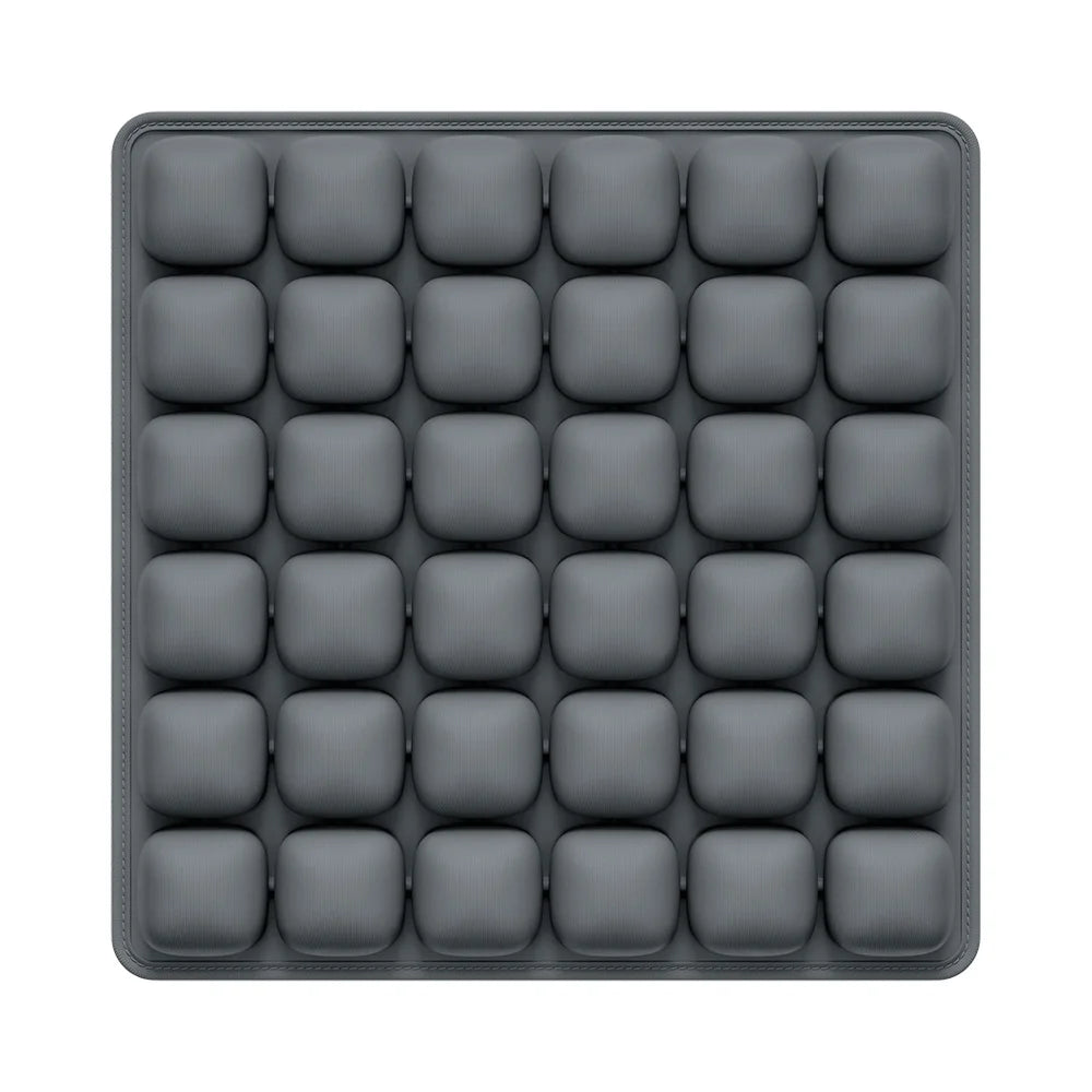 A gray seat cushion with multiple individual air pockets for adjustable pressure relief.